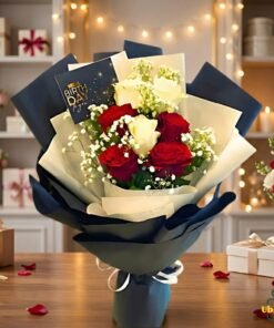 Red and white rose bouquet wrapped in elegant navy and cream paper, beautifully arranged for gifting in Pakistan.