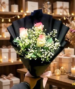 Elegant rose bouquet wrapped in black paper with baby’s breath, displayed in a gift shop setting